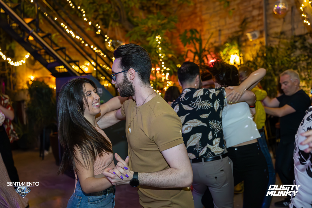 Couple dancing bachata, smiling and connected
